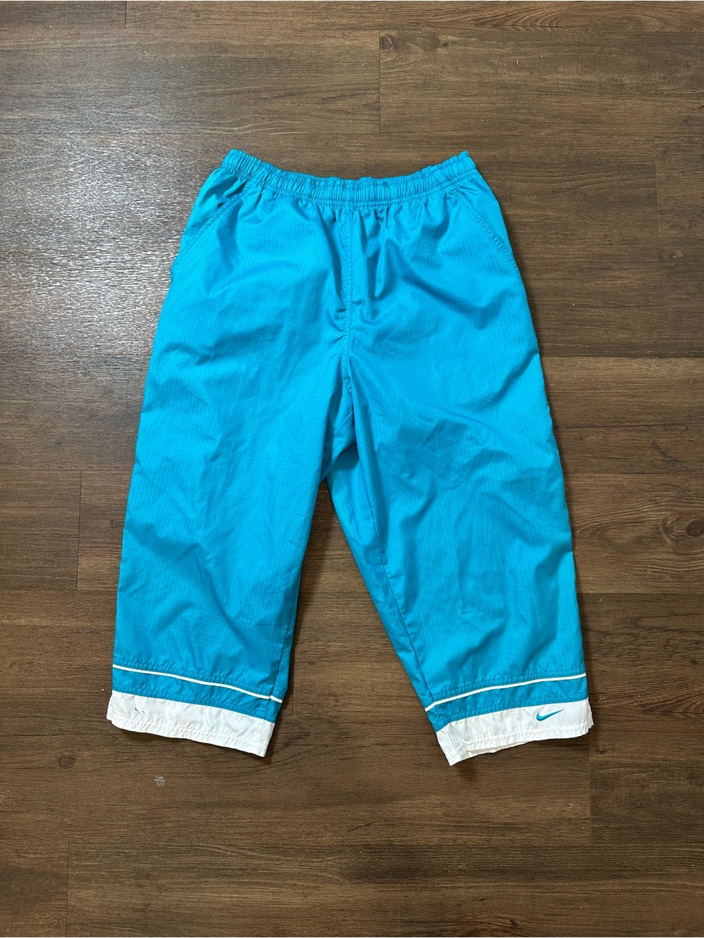 Vintage blue Nike capri track pants with white stripe and trim